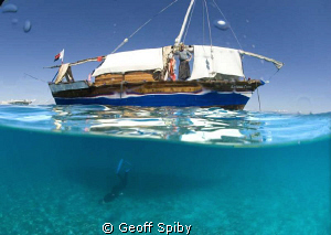 snorkelling under the dhow by Geoff Spiby 
